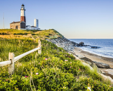 A lighthouse on the cliff offers a stunning view of the ocean.