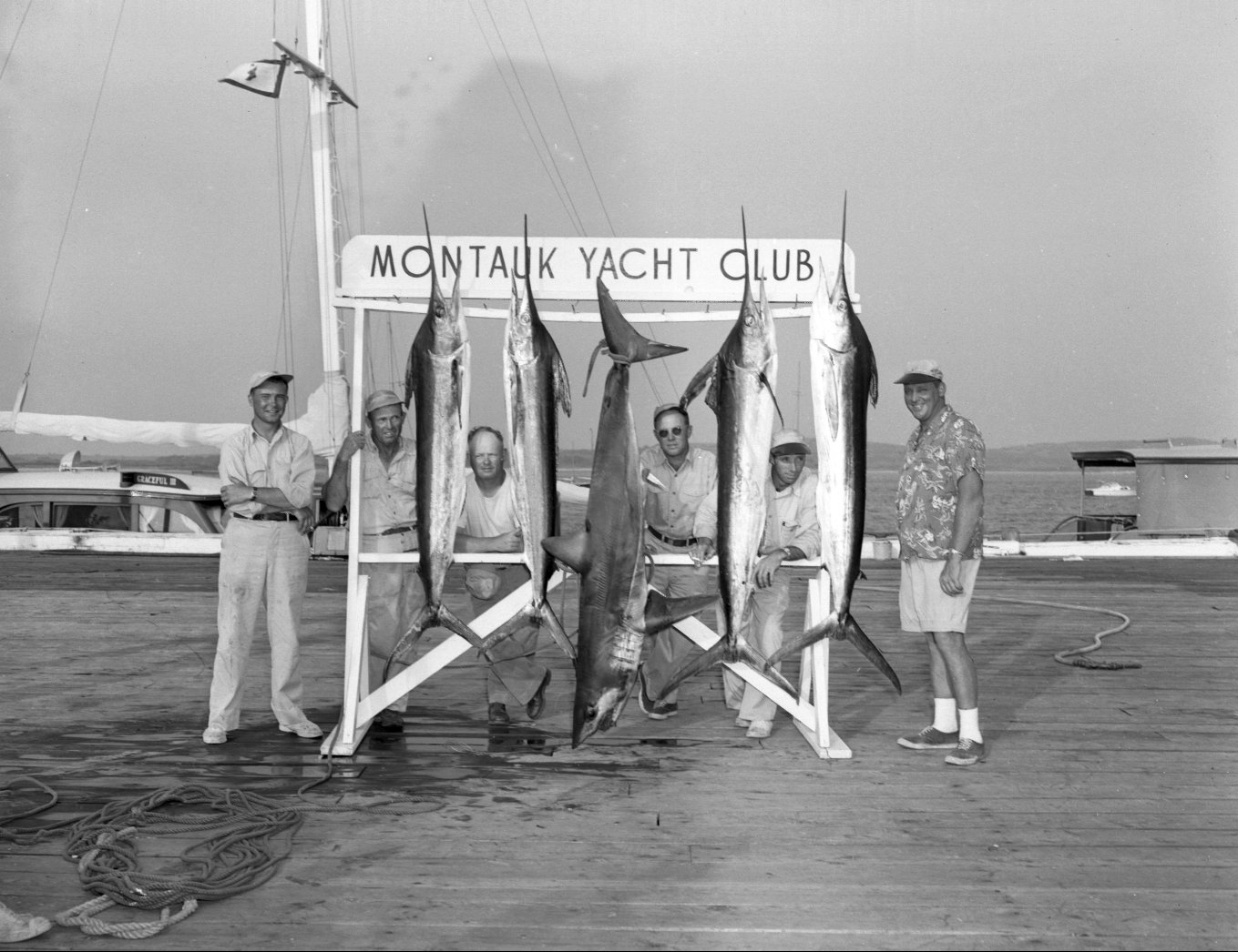 historical Montauk Yacht Club image, men standing with fish