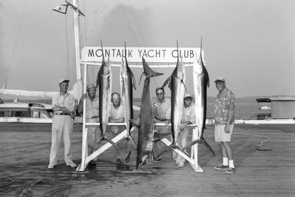 historical Montauk Yacht Club image, men standing with fish