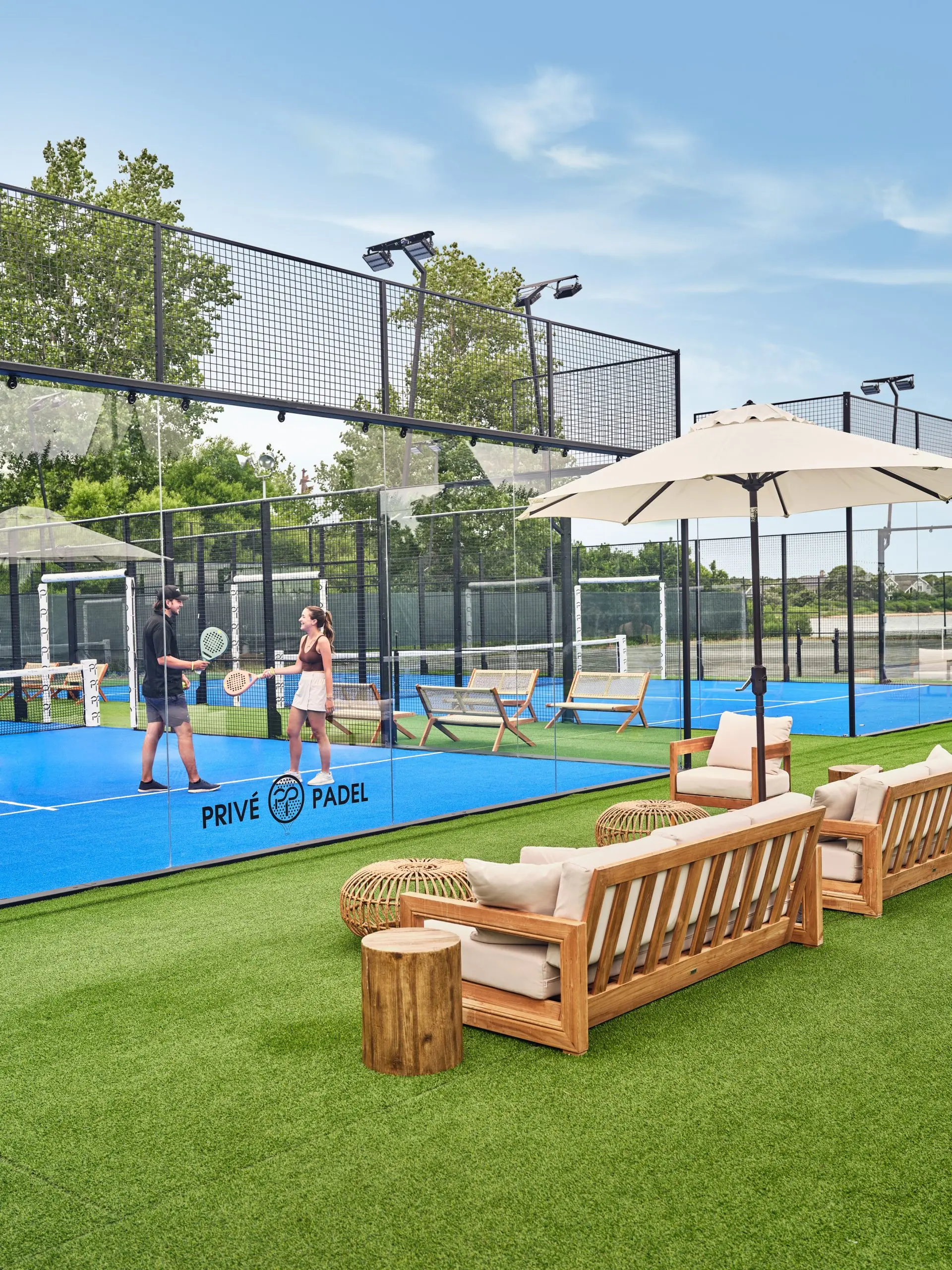 A few people playing on a tennis court.